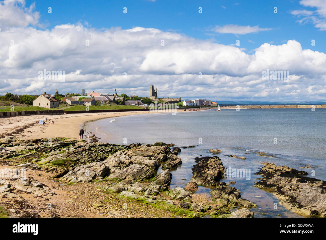 Exposed rocks at low tide on East Sands beach with stunning view to town beyond in summer. Royal Burgh St Andrews Fife Scotland UK Britain Stock Photo