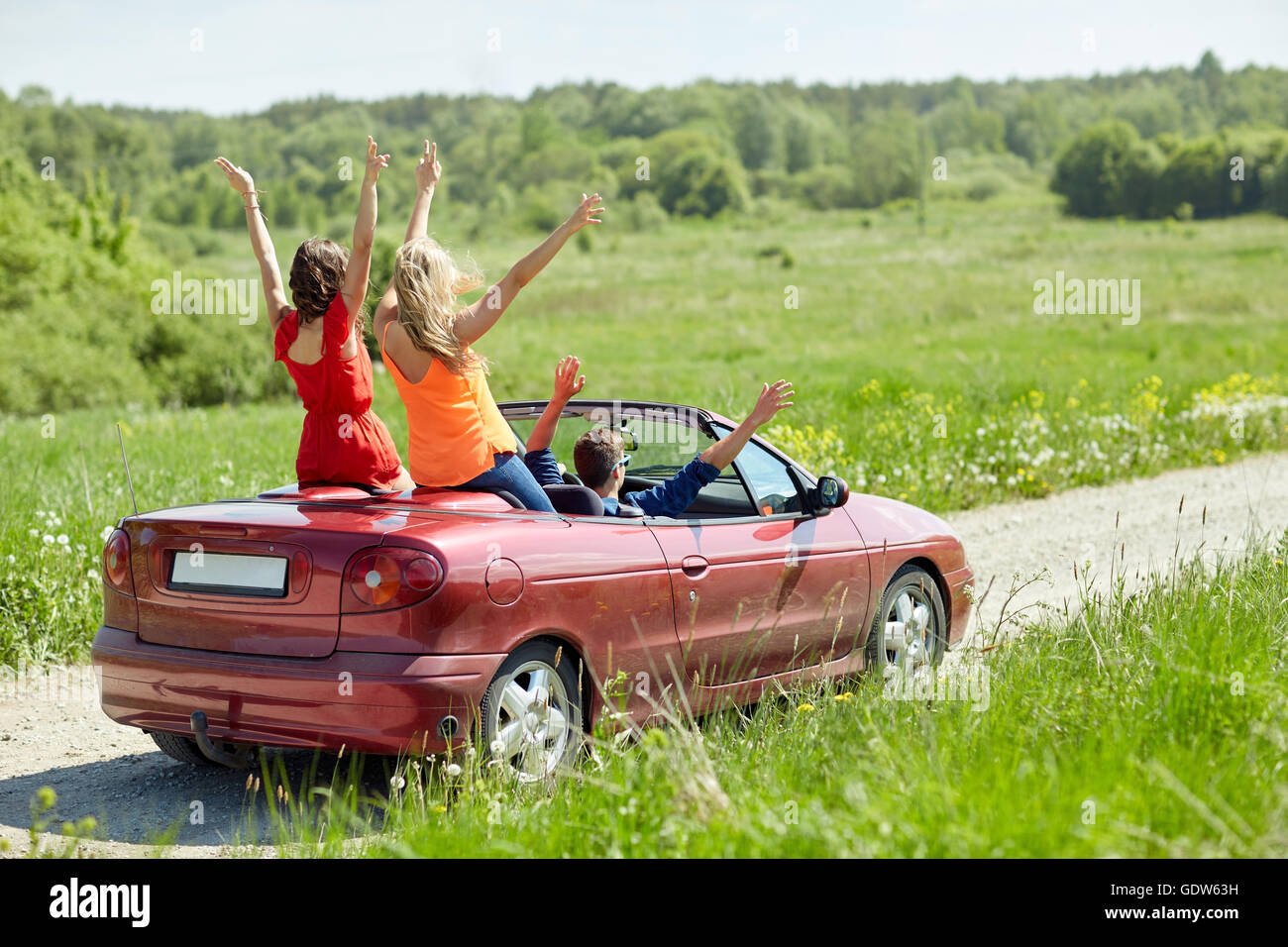 happy friends driving in cabriolet car at country Stock Photo - Alamy