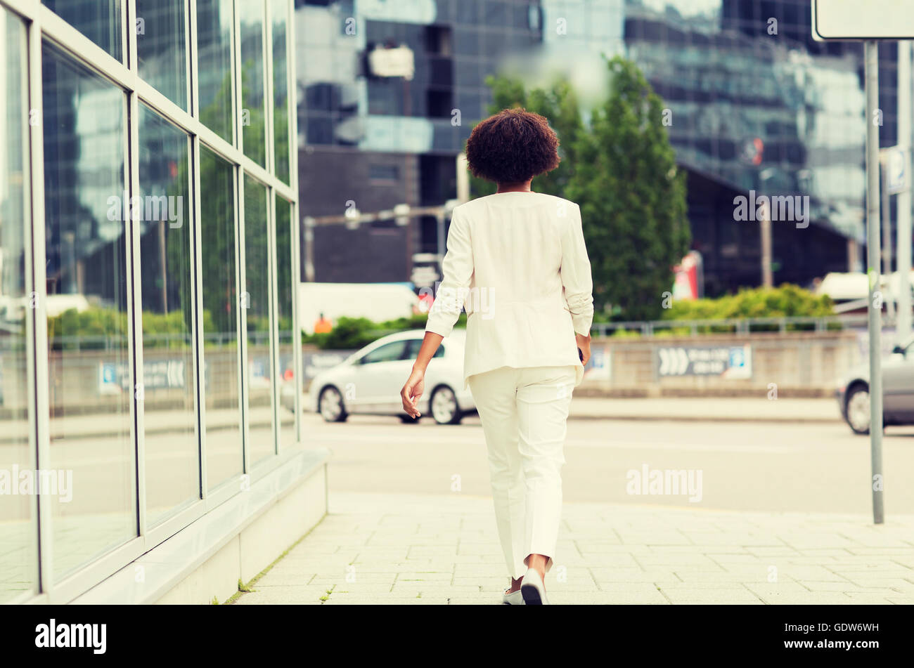African woman walking in suit hi-res stock photography and images - Alamy