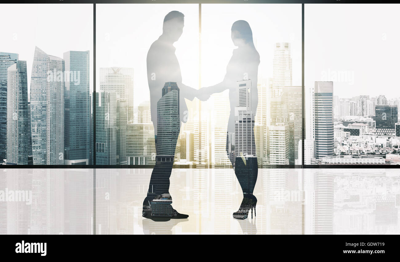 business partners silhouettes making handshake Stock Photo