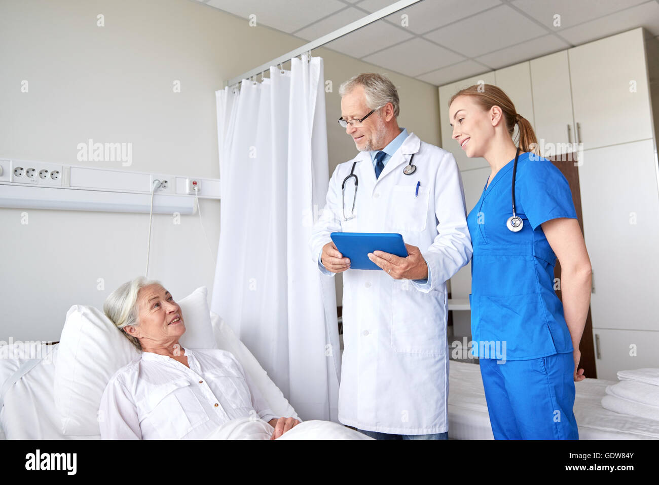 doctor and nurse visiting senior woman at hospital Stock Photo - Alamy