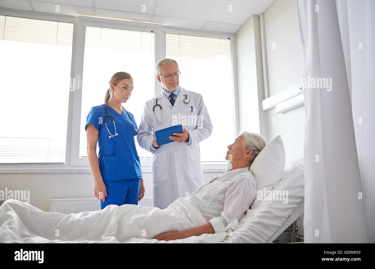 doctor and nurse visiting senior woman at hospital Stock Photo - Alamy