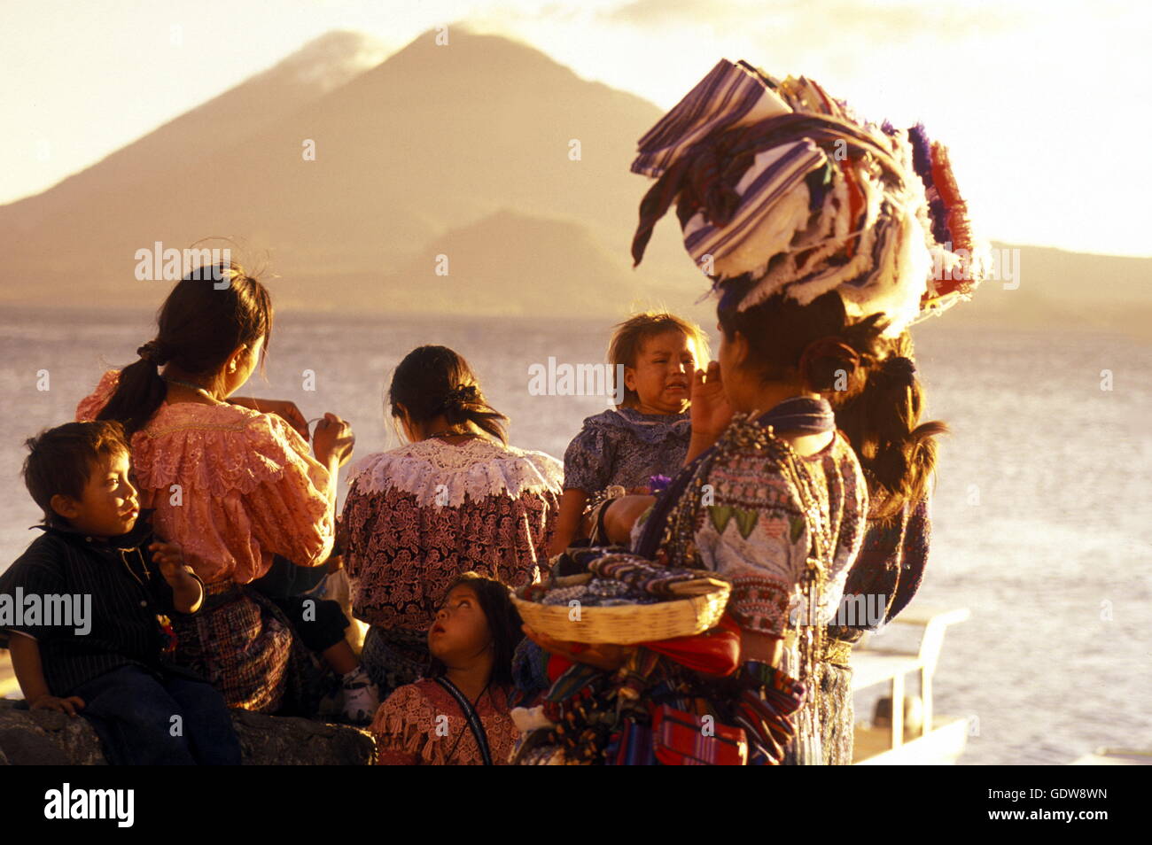People at the coast of Lake Atitlan mit the Volcanos of Toliman and San Pedro in the back at the Town of Panajachel in Guatemala Stock Photo