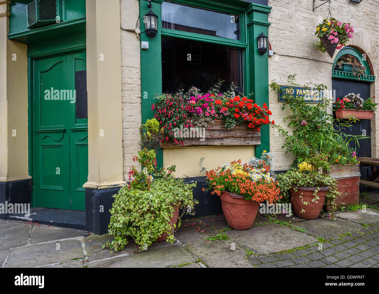 Traditional old English public house with summer flowers. Stock Photo