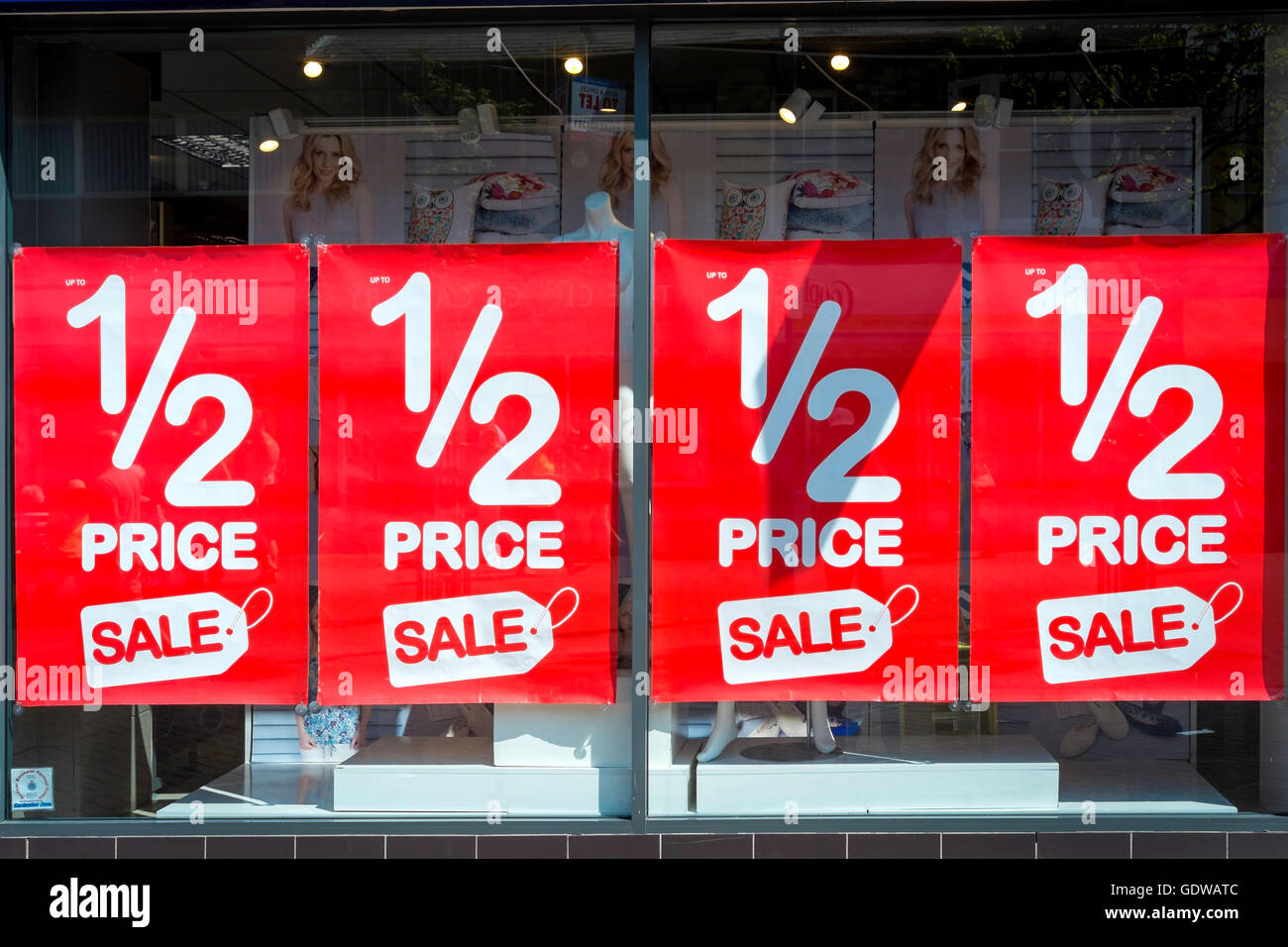 Shop window filled with four large 1/2 Price Sale posters Stock Photo