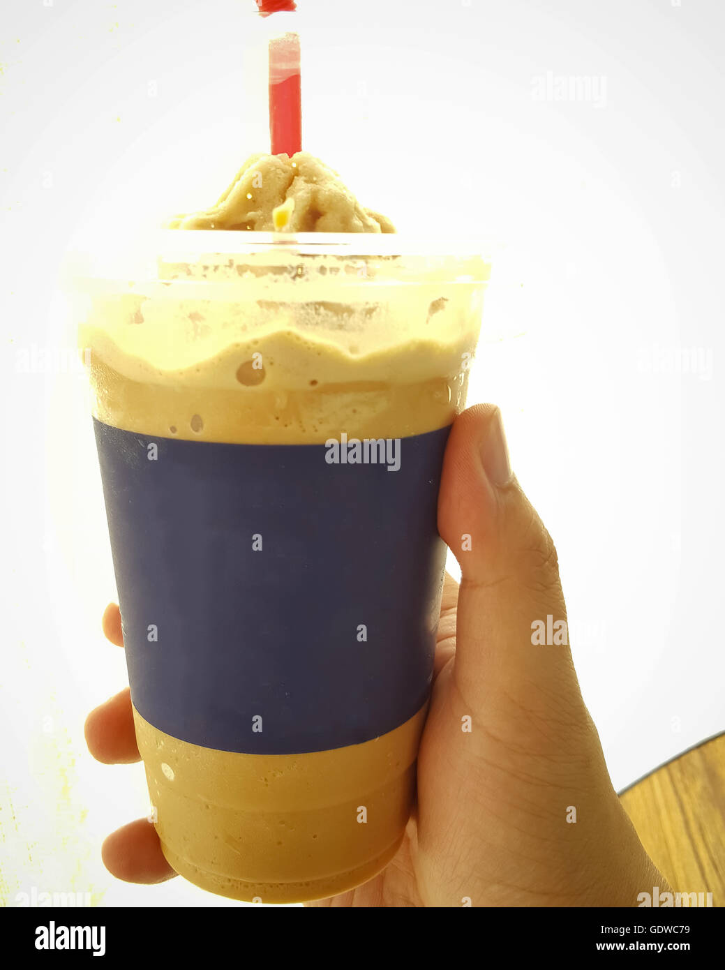 Man holding a paper cup with tube isolated over white background Stock ...