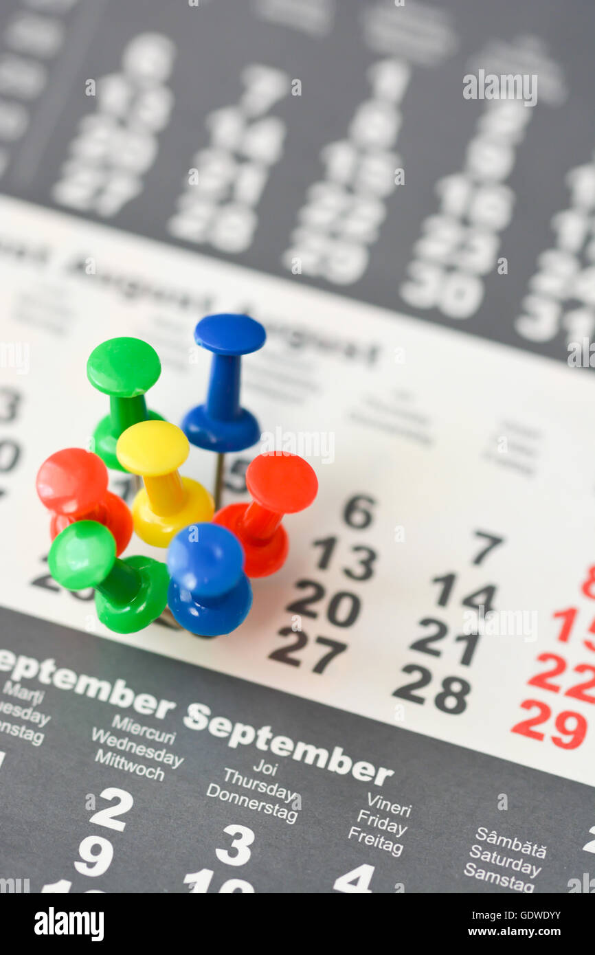 Multiple pins on a calendar suggesting busy day or schedule Stock Photo