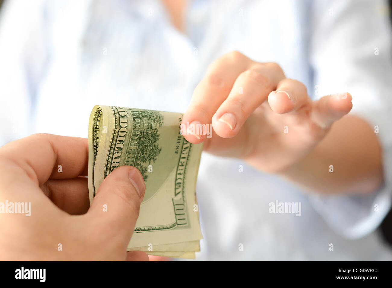 Give money to someone as bribe to suggest a corrupt system Stock Photo