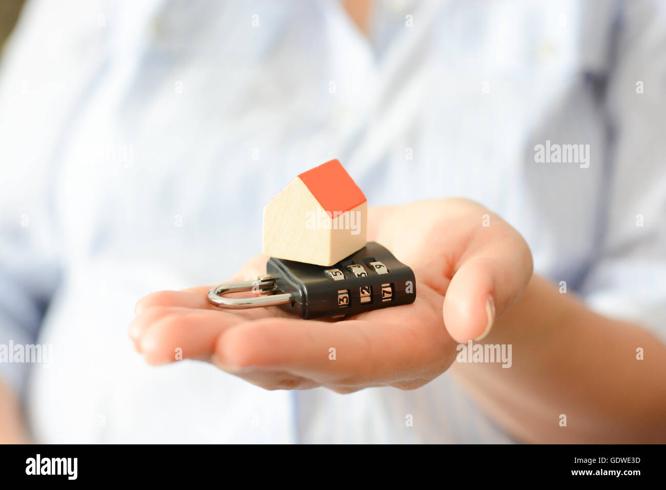 Close-up of woman’s hands holding a small model house Stock Photo - Alamy