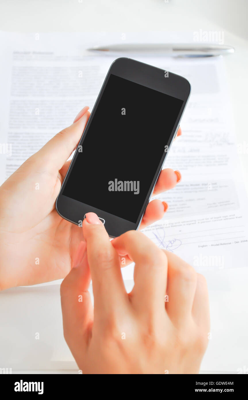 Young woman browsing smartphone with empty or blank display Stock Photo
