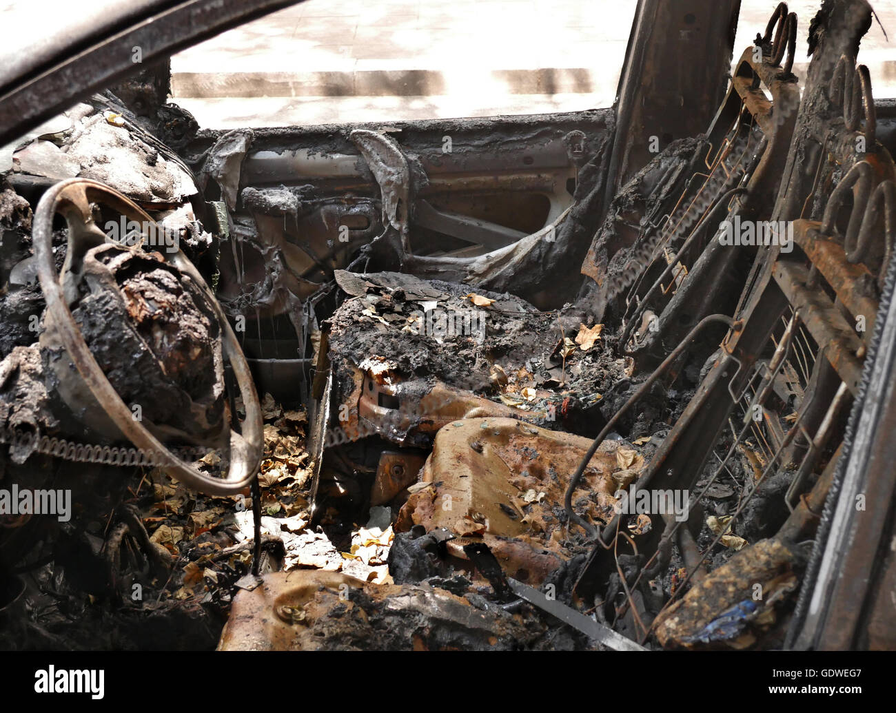 Interior of burnt-out car due to gang violence in Belgrade street, Serbia Stock Photo
