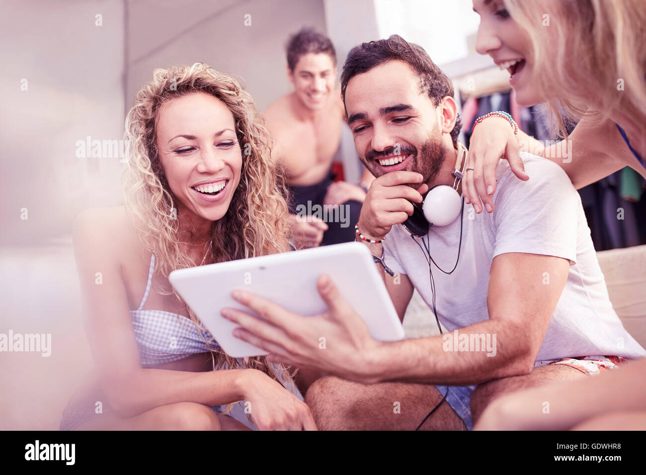 Young friends laughing using digital tablet Stock Photo