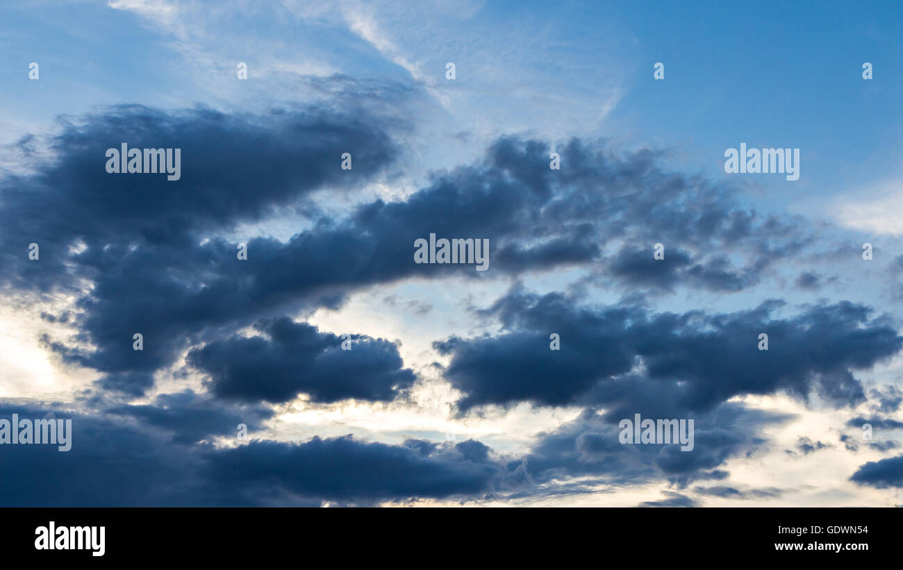 Dark clouds on blue sky background Stock Photo - Alamy