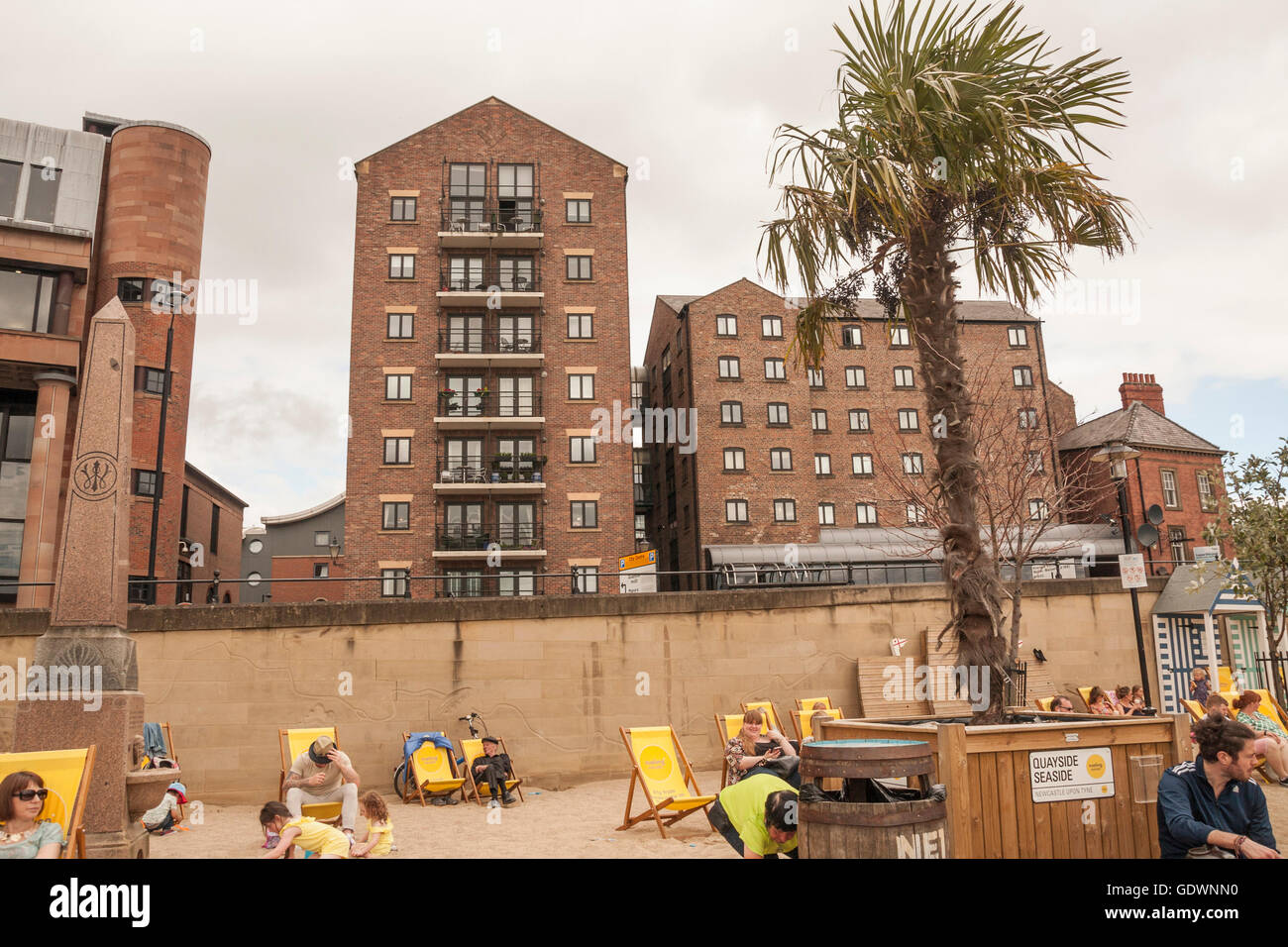 People relaxing on the pop up beach at the Quayside Seaside premises by the banks of the River Tyne at Newcastle upon Tyne Stock Photo