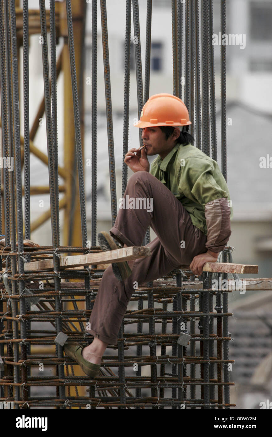 A worker sits at a construction site Stock Photo - Alamy