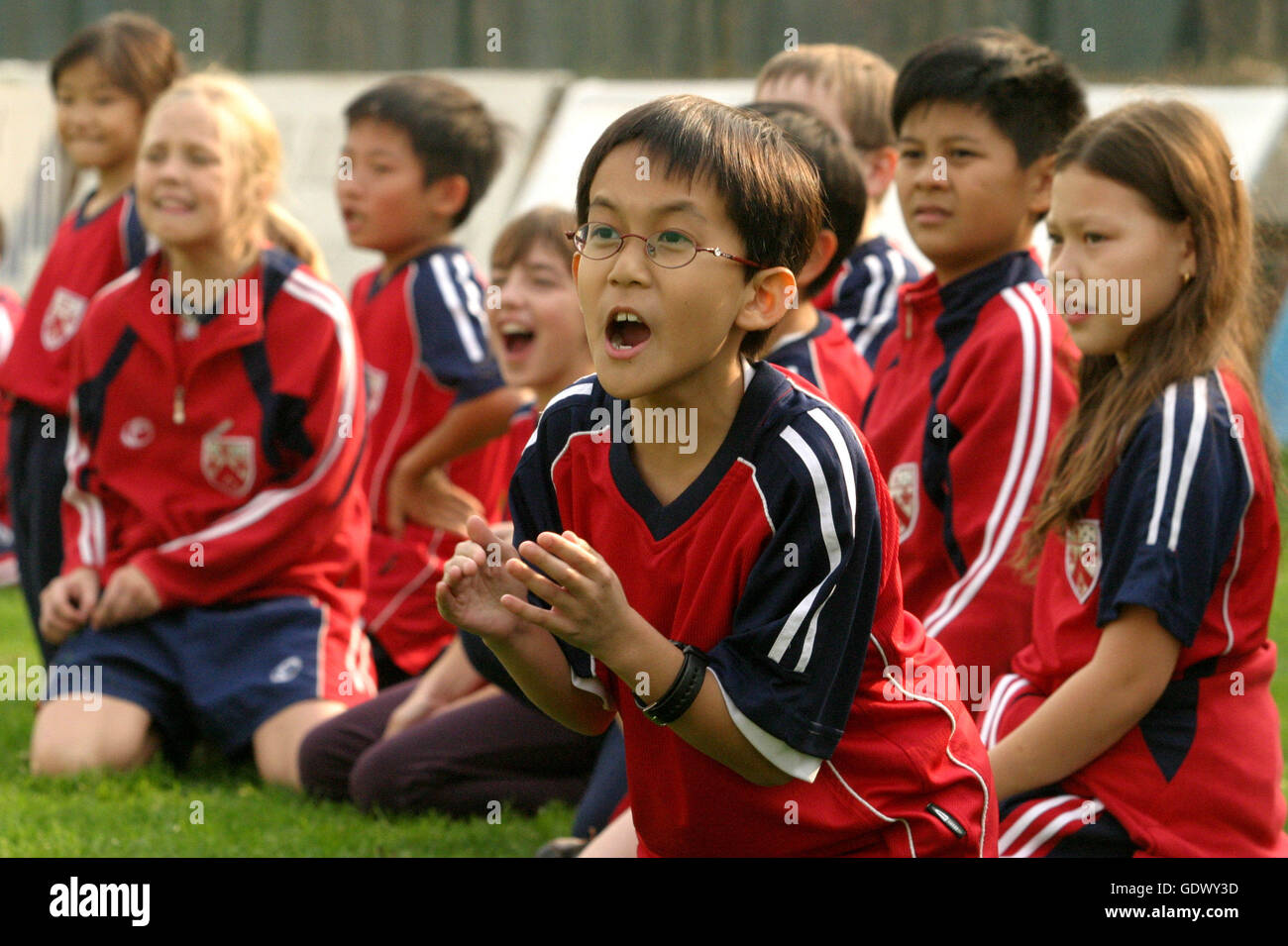 Dominic Lim from Singapore cheers his team mate in a sport event of Dulwich  College Shanghai Stock Photo - Alamy