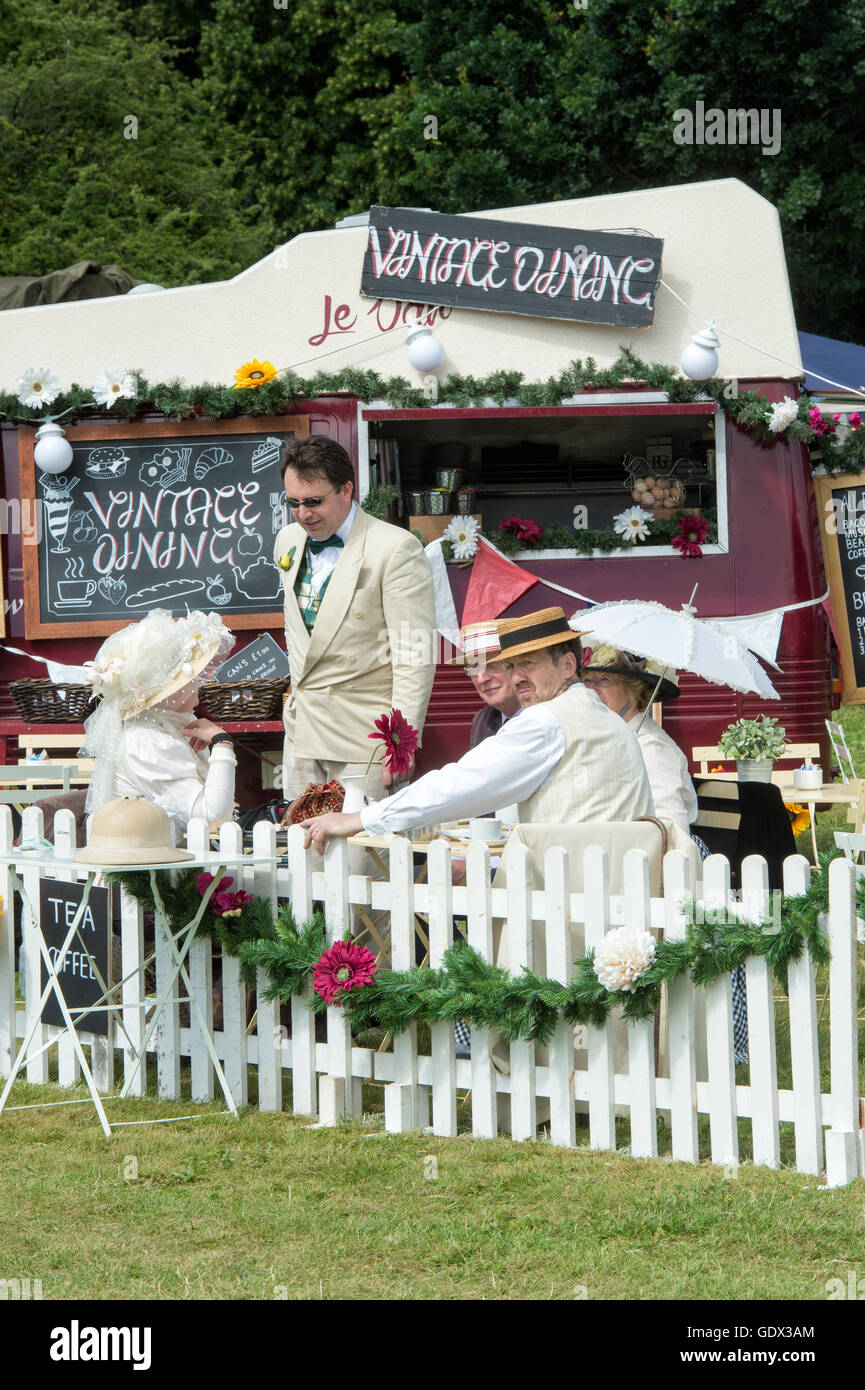 People in Victorian costumes in the vintage dining area at the Thames Traditional Boat Festival, Henley On Thames, England Stock Photo