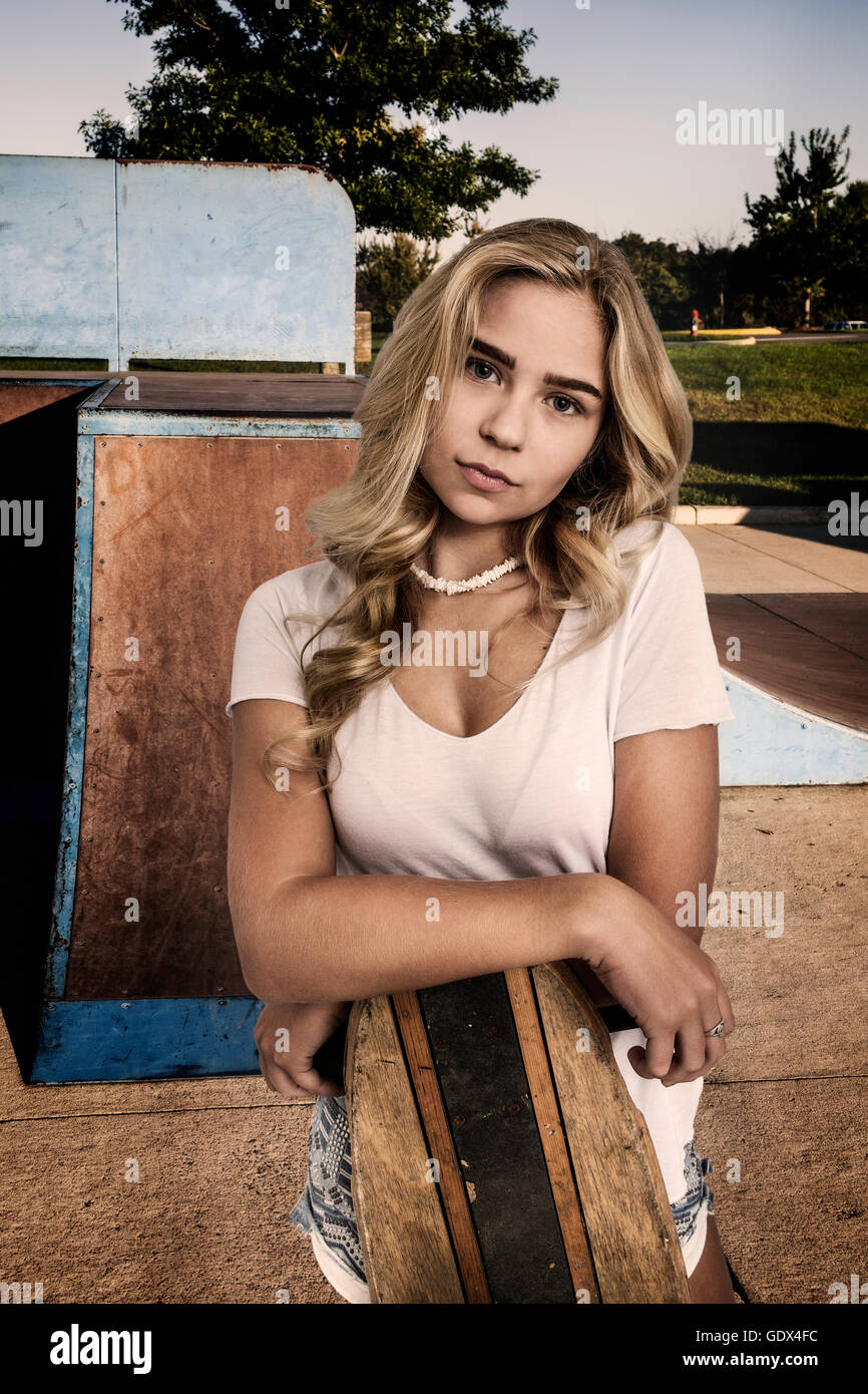 Beautiful Blond Girl Wearing White Shirt And Jean Shorts Standing