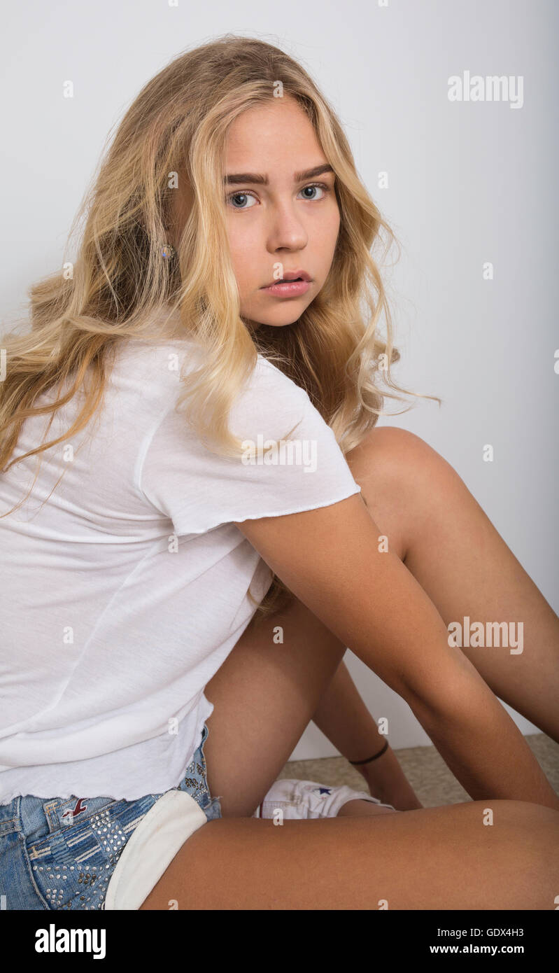 Beautiful blond girl with long hair wearing white shirt Stock Photo - Alamy