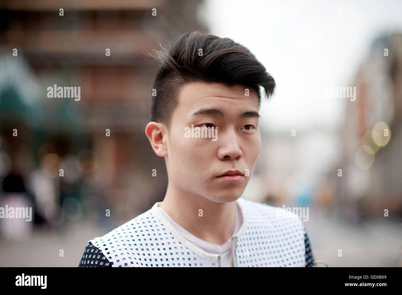 Man with a 'rockabilly' hair style  and wearing breathable sports-Lux top, London, LFW.. Stock Photo