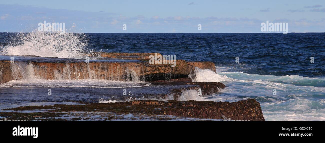 Waves splashing over rocks near Maroubra Beach, Sydney. Stock Photo
