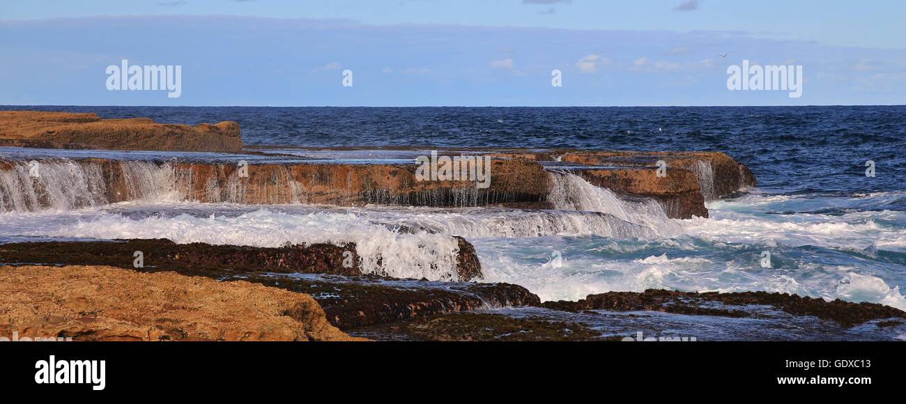 Scene near Maroubra Beach, Sydney. Pacific water flowing over rocks. Stock Photo