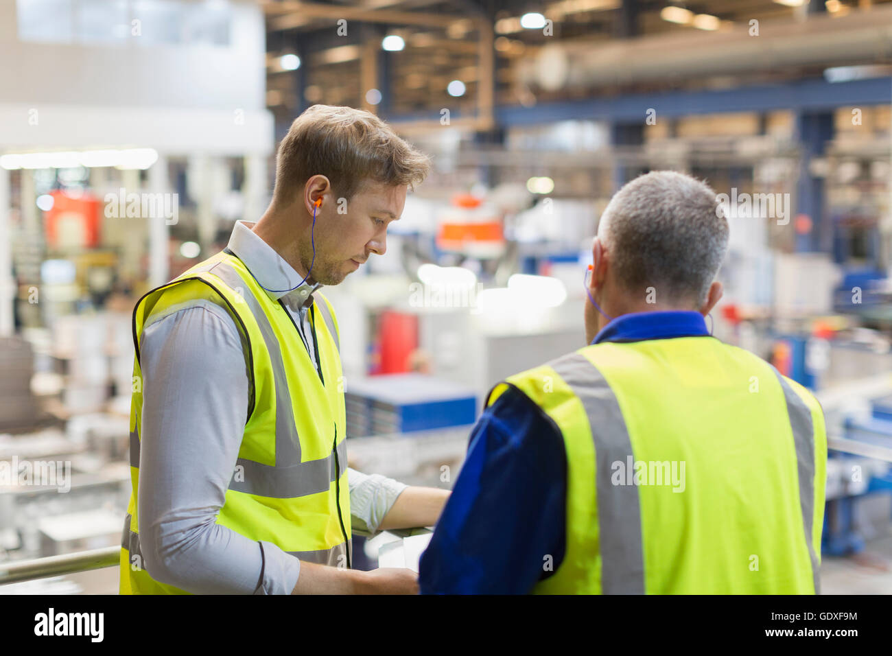 Supervisor Talking Supervisors talking on platform above steel factory Stock Photo - Alamy