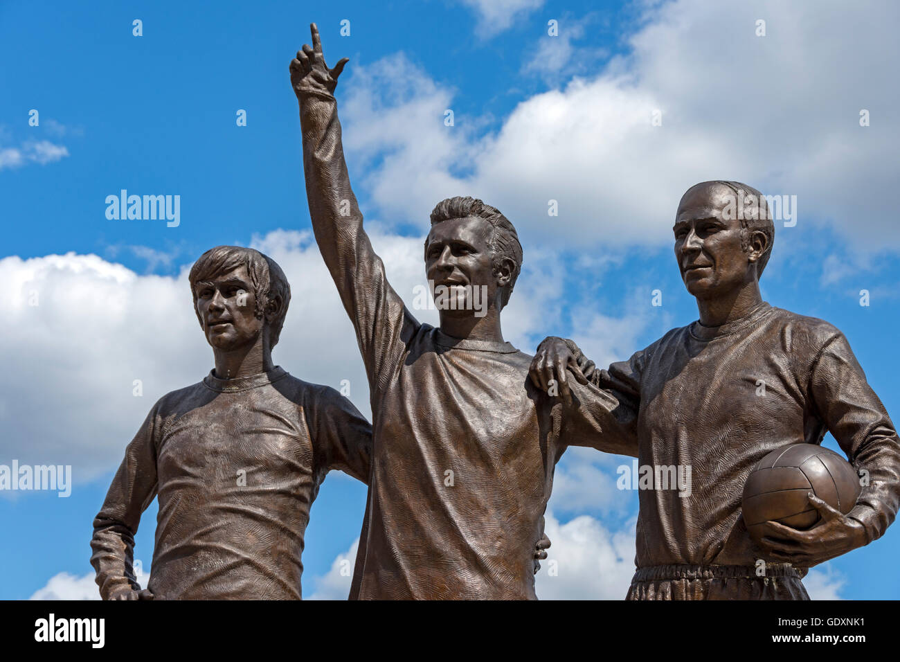 'The United Trinity', a sculpture by Philip Jackson, at the Manchester United stadium, Old Trafford, Manchester, England, UK. Stock Photo