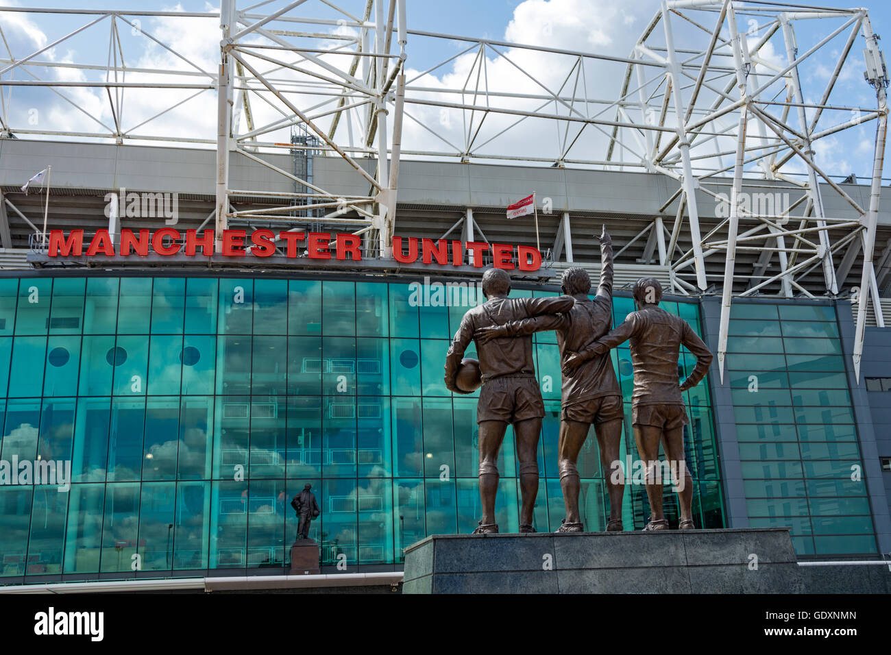 'The United Trinity', a sculpture by Philip Jackson, at the Manchester United stadium, Old Trafford, Manchester, England, UK. Stock Photo