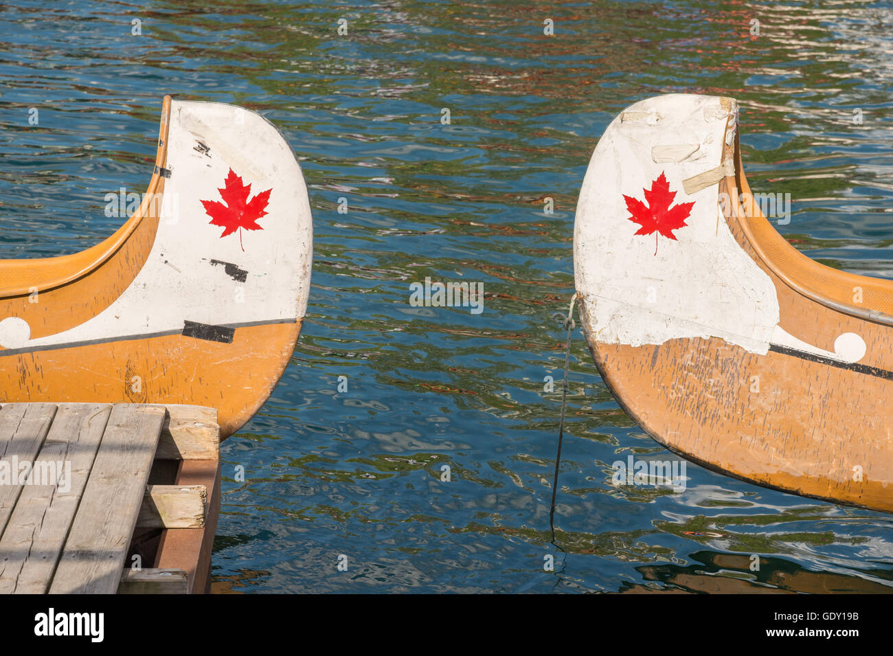 Ends of two canoes with copyspace and canadian red maple leaf Stock Photo