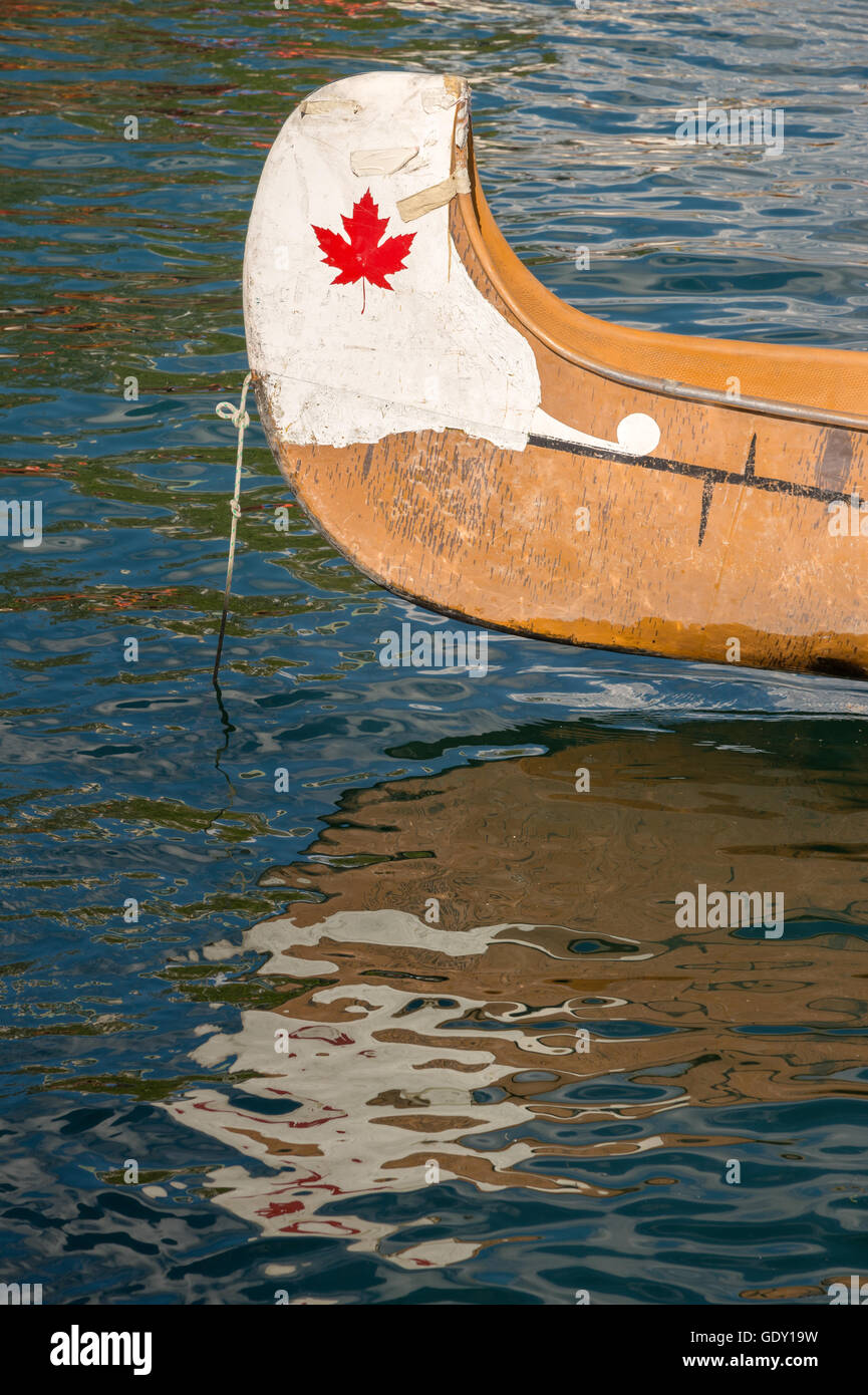 End of a white canoe with copyspace and red maple leaf Stock Photo