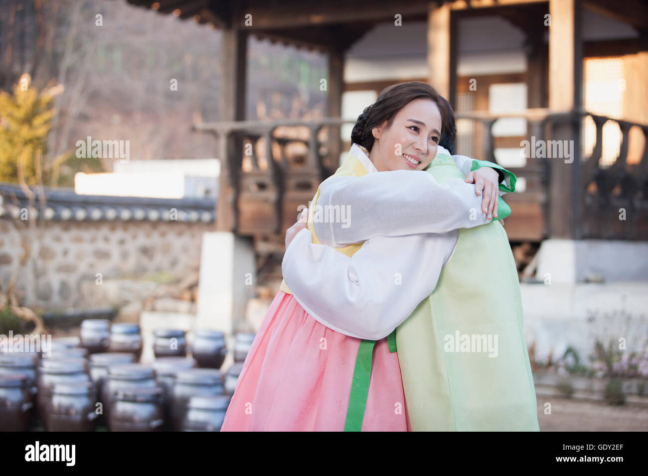 Side view of young Korean couple hugging each other Stock Photo