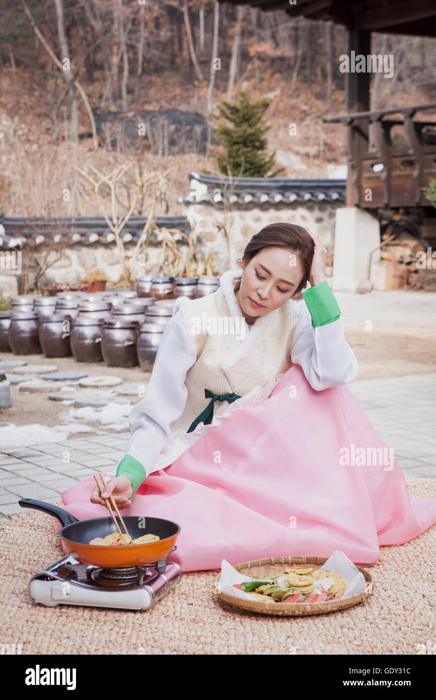 Tired Korean woman cooking traditional Korean food Stock Photo Alamy