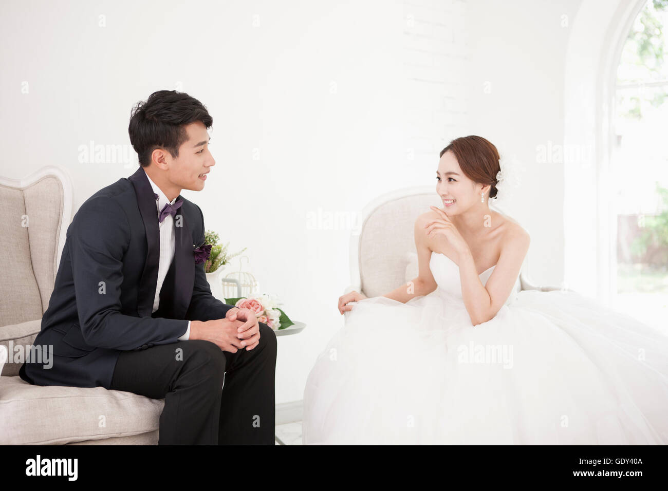 Bride and groom sitting smiling hi-res stock photography and images - Alamy
