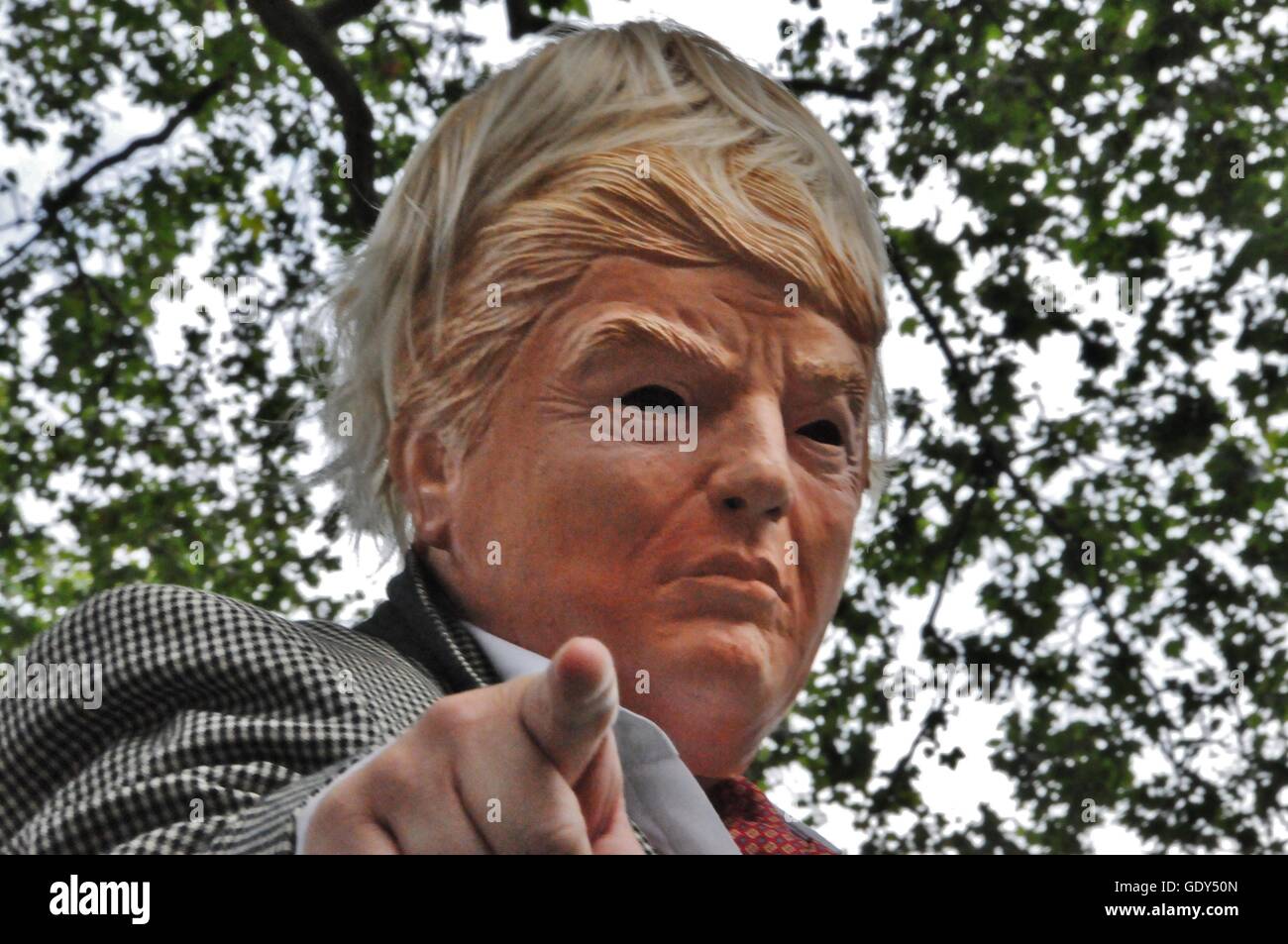 Andrew Webb aka Chopper in Donald Trump mask, rudely points at the camera. Stock Photo