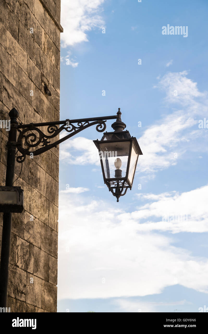 Old street lamp in wrought iron. Stock Photo