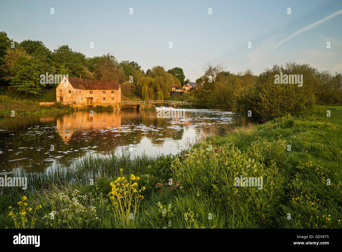 Early morning landscape across River to old Mill Stock Photo