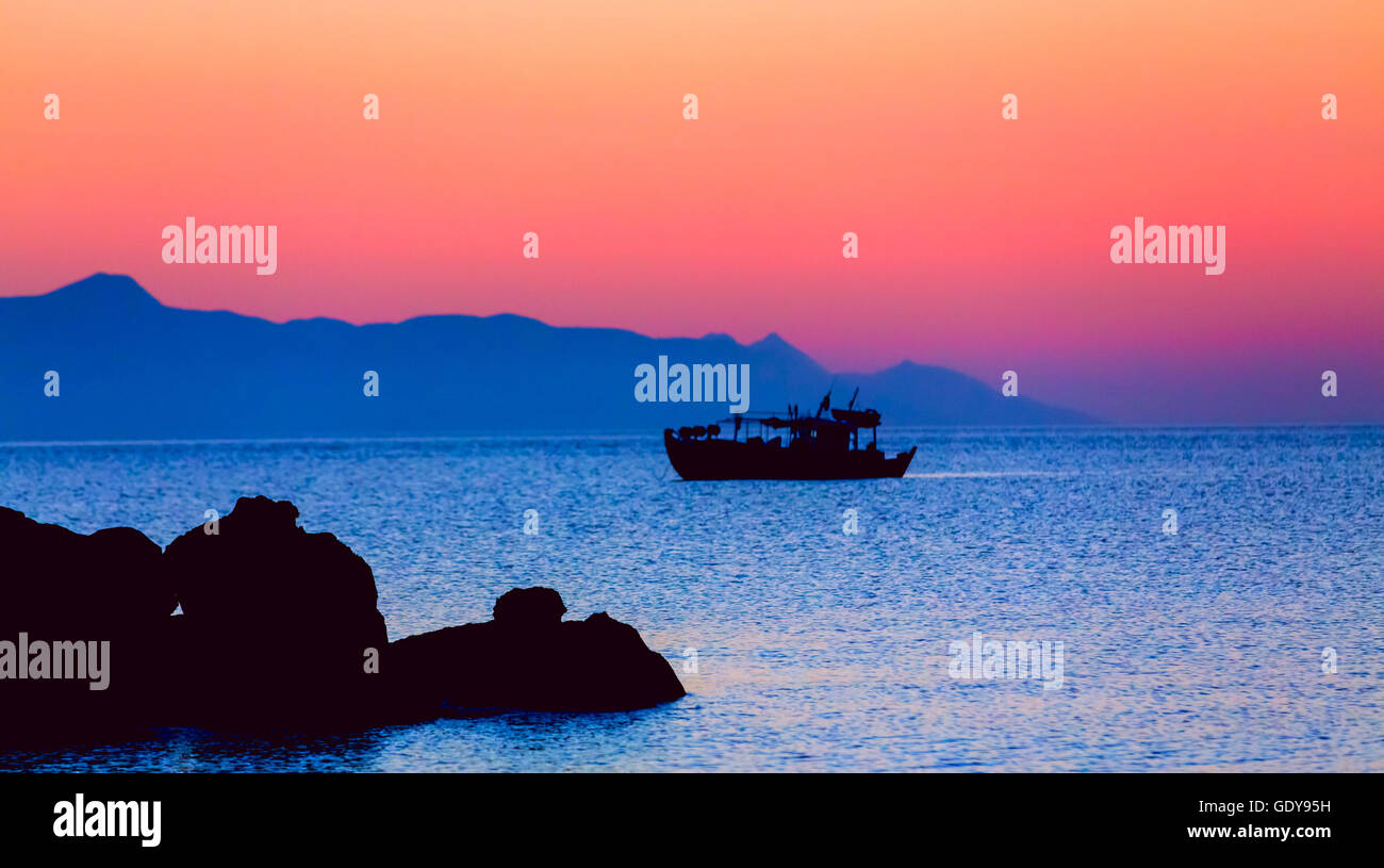 fisherman boat at sunset Stock Photo - Alamy