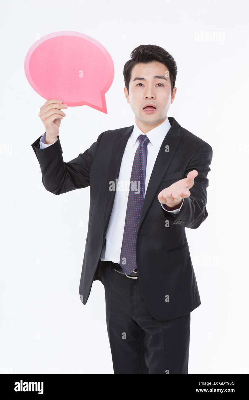 Business man standing showing a speech balloon Stock Photo