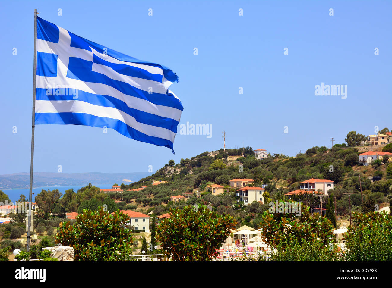 The Greek flag flying above Kephalonia, Greece Stock Photo