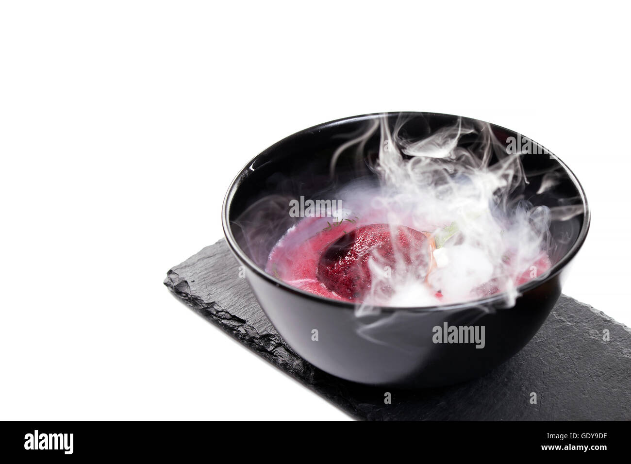 Molecular Cuisine. Delicious modern soup with beetroot. Isolated on white. Stock image. Stock Photo