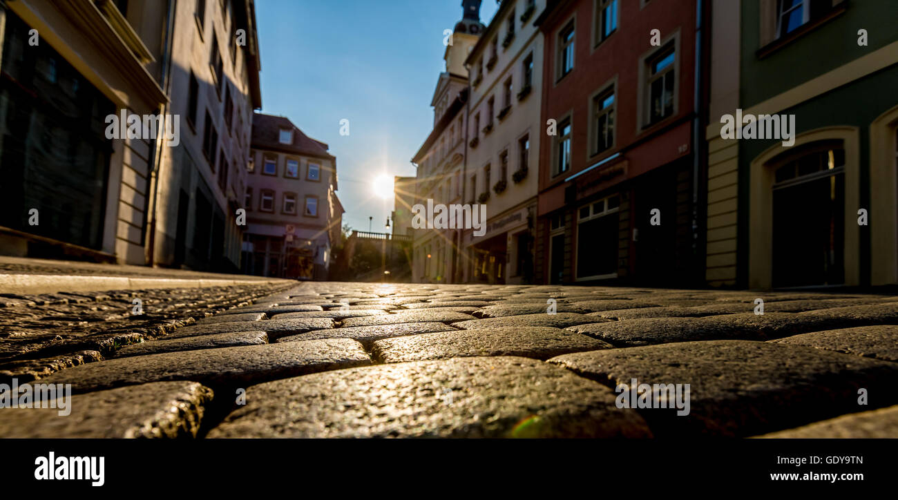 Sunrise in a city street with paving stones Stock Photo