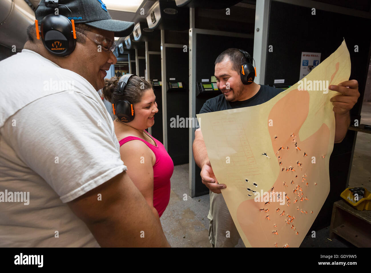 Las Vegas, Nevada - A woman examines her target after practicing with her handgun at the Discount Firearms + Ammo. Stock Photo