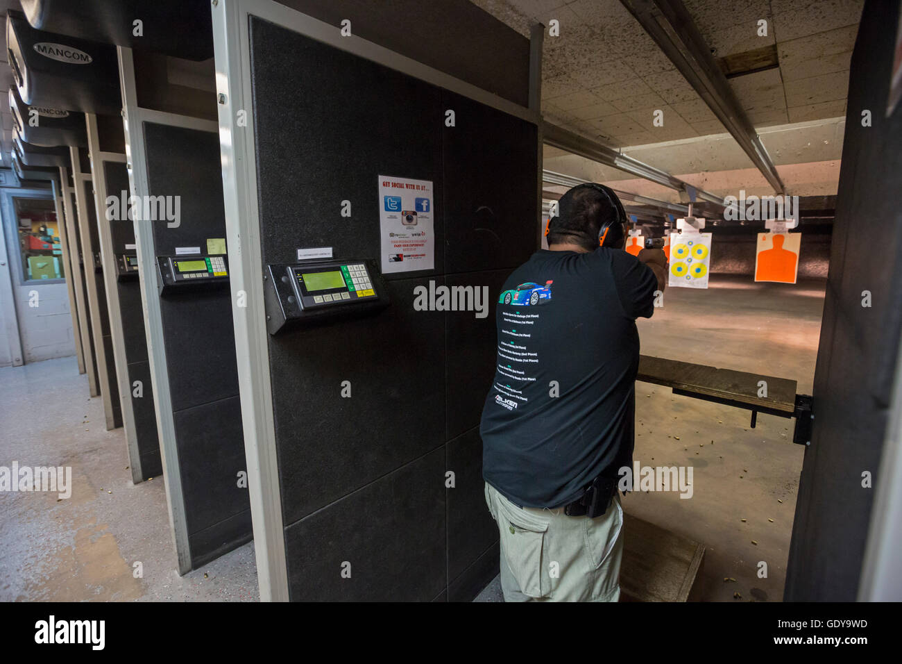 Las Vegas, Nevada - A man fires his handgun at the Discount Firearms + Ammo indoor shooting range. Stock Photo