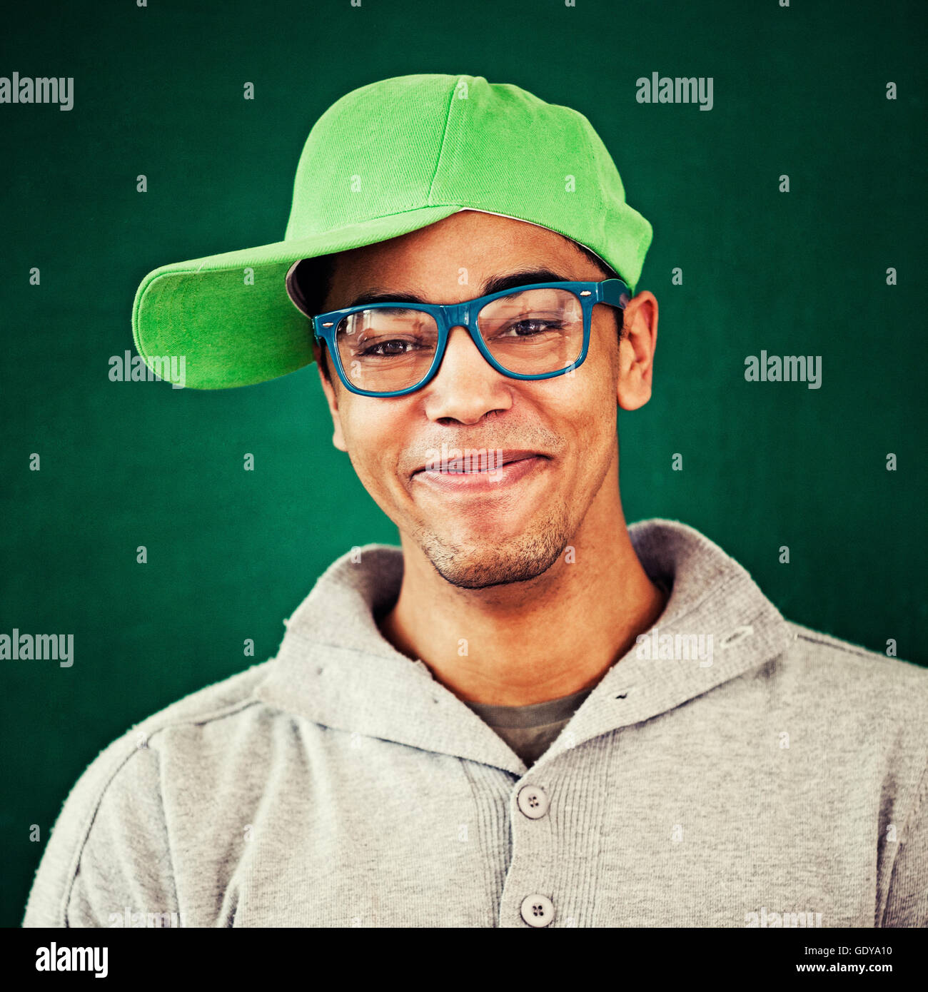 Smiling African rapper wearing a cap and blue glasses. Stock Photo