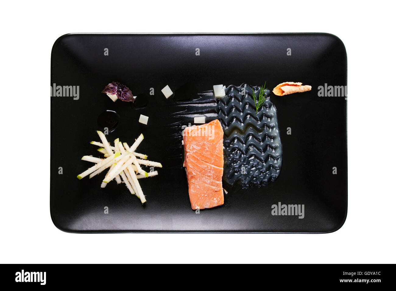 Molecular modern cuisine red fish in a dish with beautiful garnish close up. Isolated Stock Photo