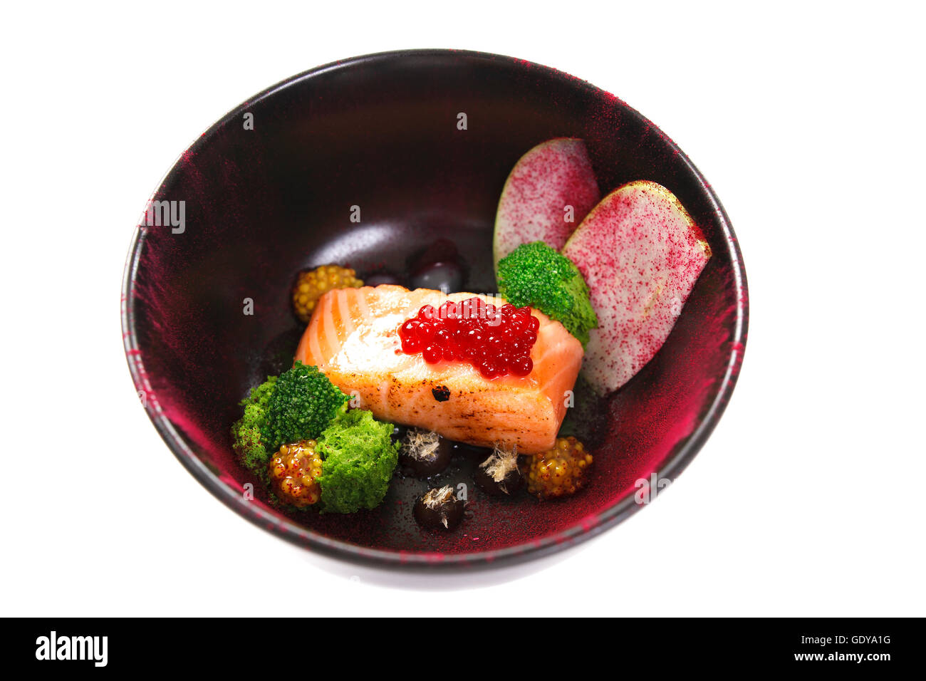 Molecular modern cuisine red fish in a dish with beautiful garnish