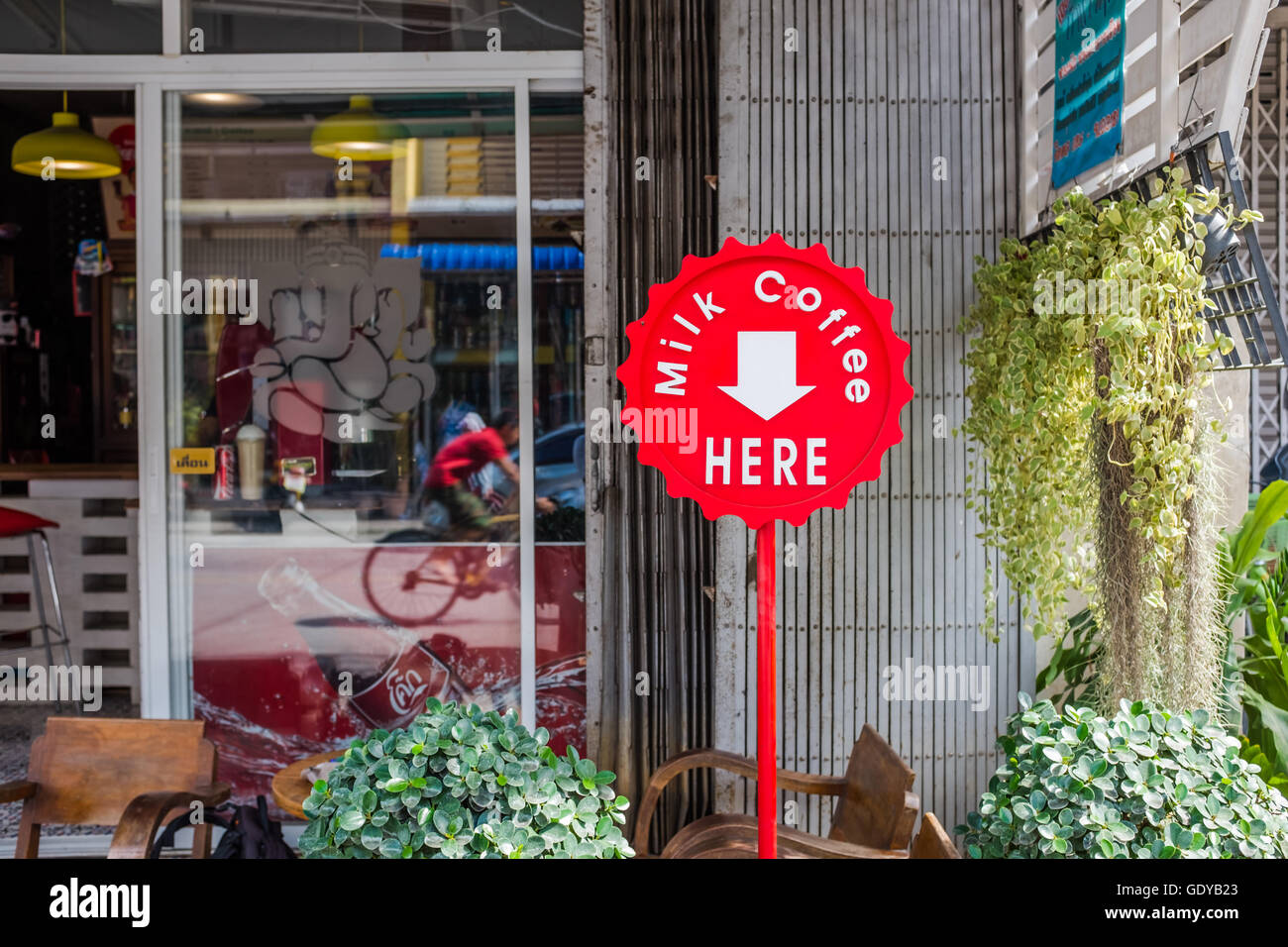 Red sign outside coffee shop advertising milk coffee,Chiang Mai
