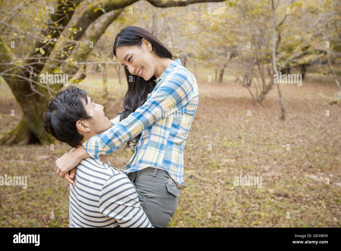 Portrait of couple hugging in park hi-res stock photography and images ...