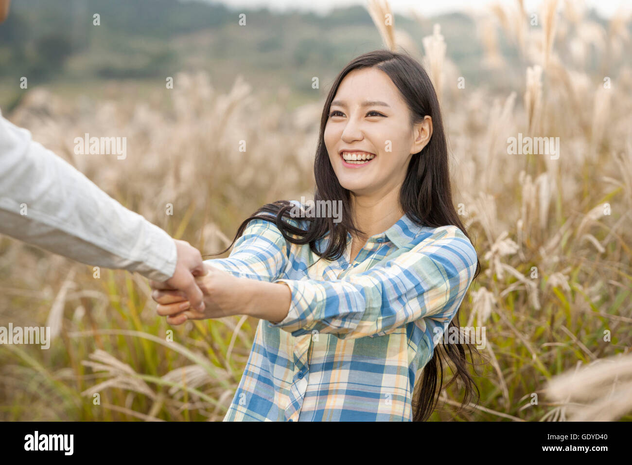 Young man woman holding hands hi-res stock photography and images - Alamy